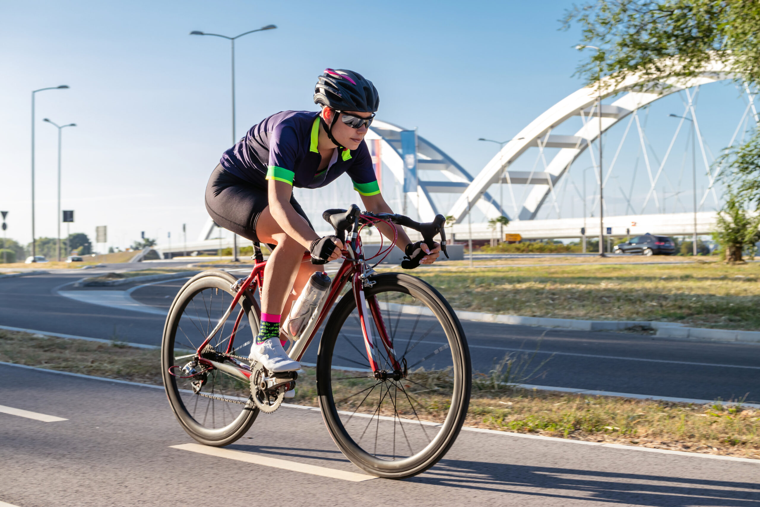 Female cyclist riding a bicycle outdoors. Sports women cycling competition. Racing at high speed. Healthy lifestyle concept. Motion blur.